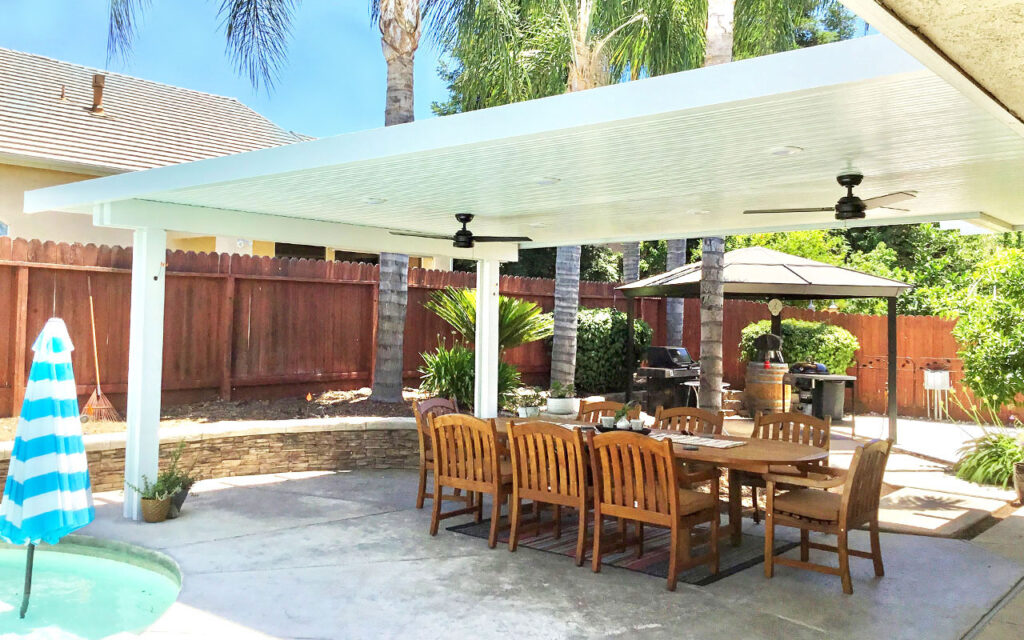 A shady area under a patio with table and chairs.